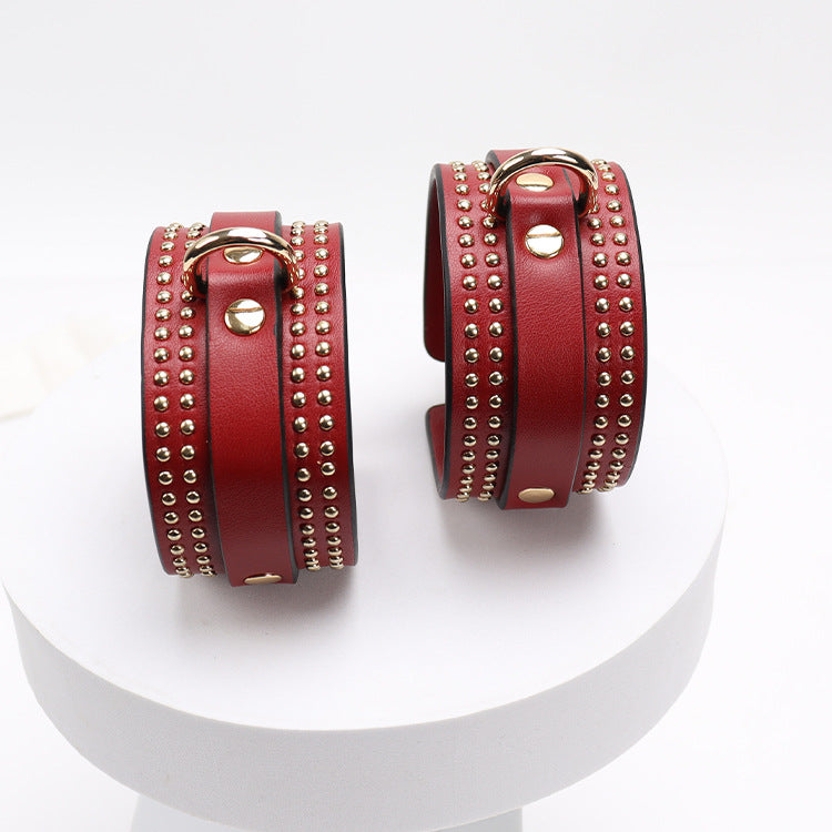 Wholesale Rivet Bondage Starter Kit in Red hand cuff